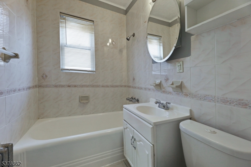 90 Norman Road Newark, NJ 07106 - Photo 22 of 31 a bathroom with a sink toilet and tub