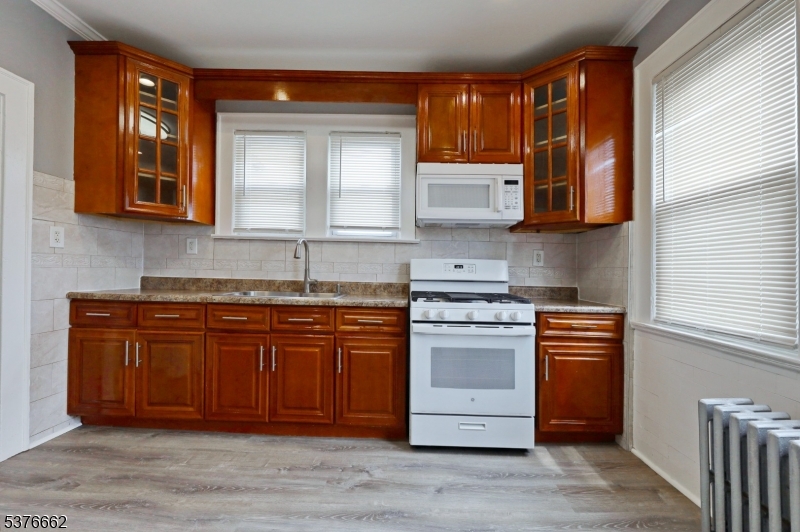90 Norman Road Newark, NJ 07106 - Photo 24 of 31 a kitchen with stainless steel appliances granite countertop a sink stove and cabinets