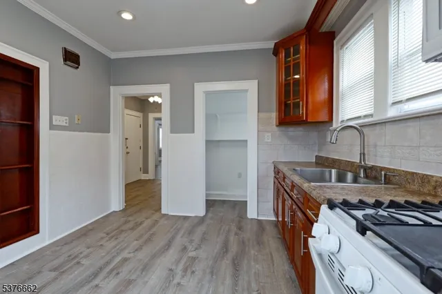 a kitchen with a stove a refrigerator and a sink