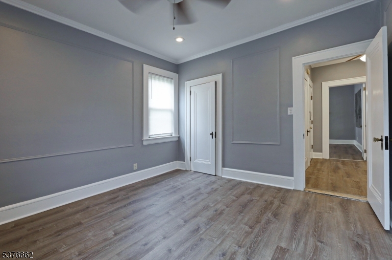 90 Norman Road Newark, NJ 07106 - Photo 29 of 31 an empty room with wooden floor and windows