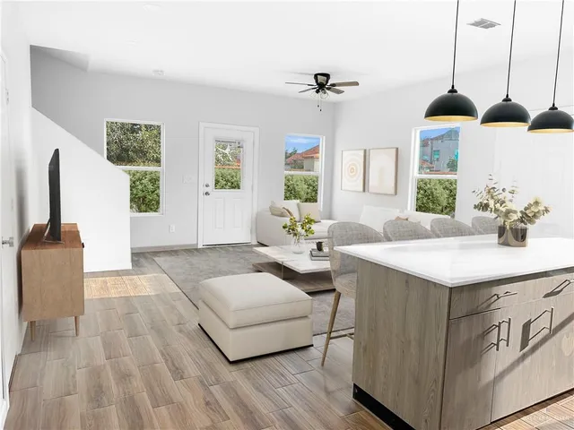 a spacious bedroom with a bed a window and dresser