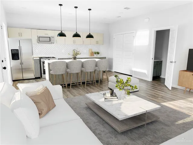 a living room with furniture and wooden floor