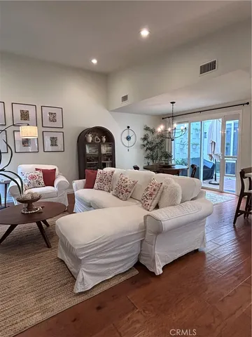 a spacious bedroom with a bed a couch and large window