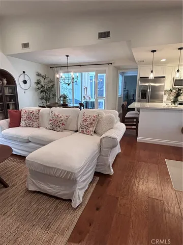 a living room with furniture and a chandelier