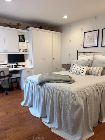 a bedroom with a bed and a desk