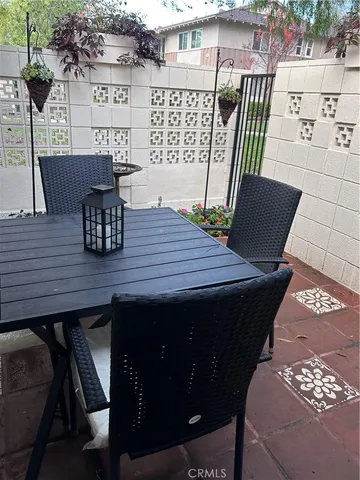 a view of a wooden table and chairs in patio
