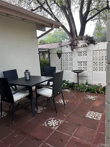 a view of a patio with table and chairs and potted plants