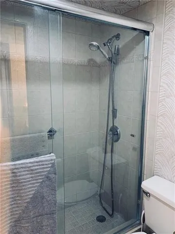 a bathroom with a shower and toilet