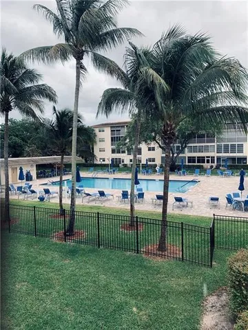 a view of a swimming pool and lounge chairs