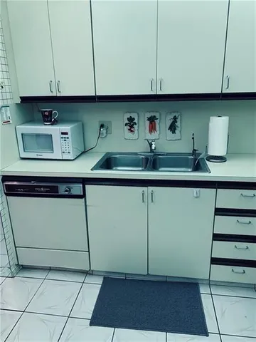 a kitchen with a sink and cabinets