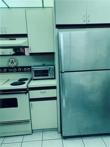 a kitchen with a refrigerator and a stove