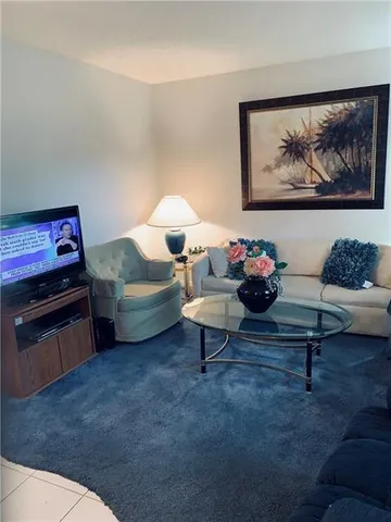 a living room with furniture and a mirror