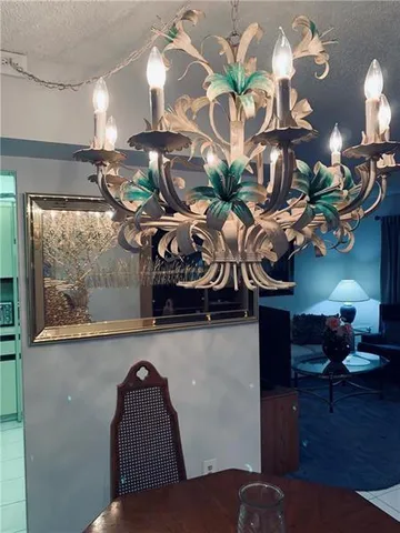 a dining room with furniture and chandelier