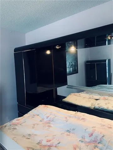 a bedroom with a bed and a fireplace