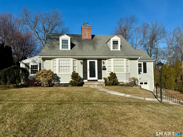 a view of a house with backyard sitting area and garden
