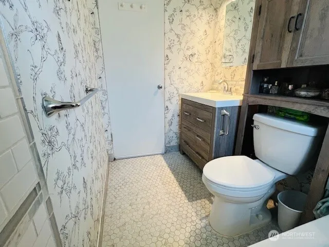 a bathroom with a toilet and a shower curtain