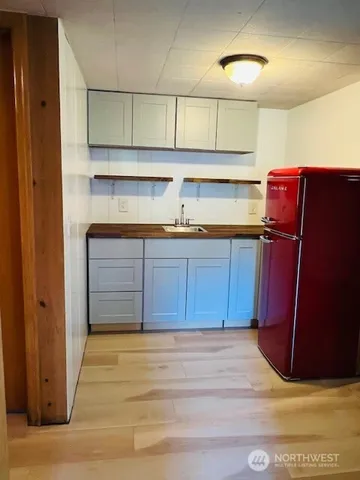 a kitchen with a sink and wooden cabinets