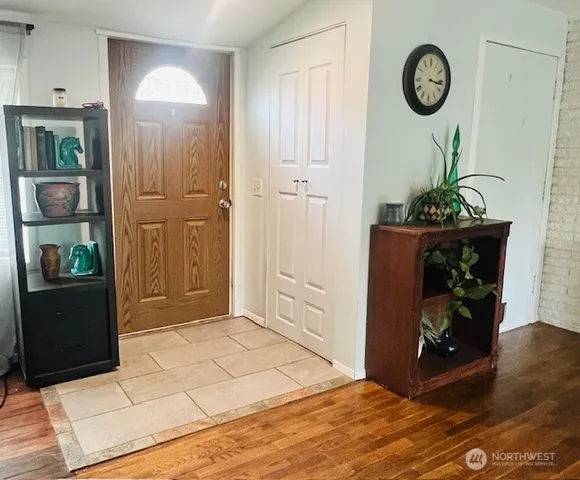 a view of an entryway with wooden floor