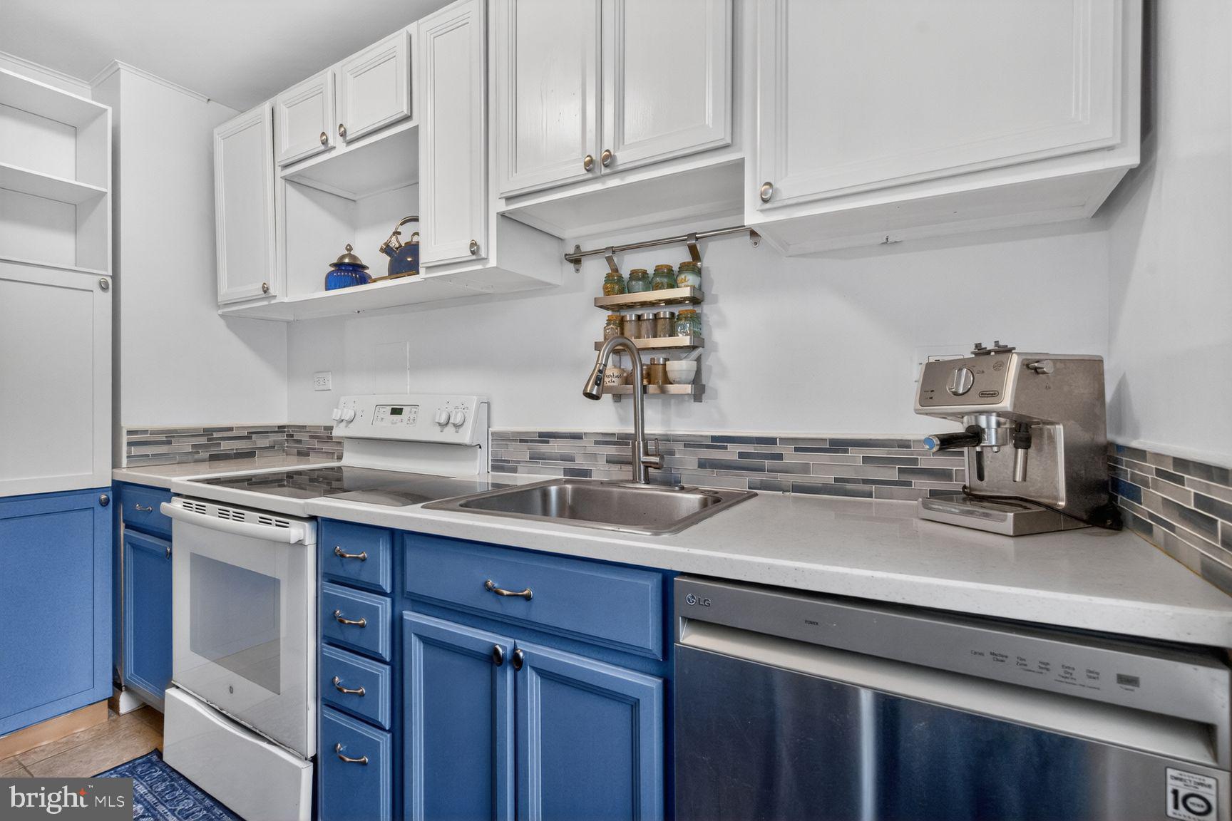 51 Ridge Road Greenbelt, MD 20770 - Photo 2 of 23 a kitchen with stainless steel appliances granite countertop a sink stove and cabinets