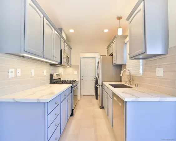 a kitchen with a sink stove and cabinets