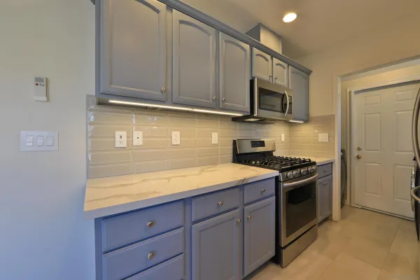 a kitchen with stainless steel appliances granite countertop a stove and a microwave