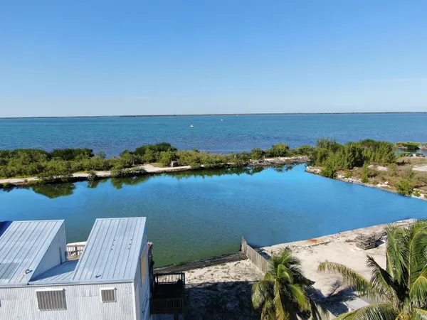 an aerial view of a house with ocean view