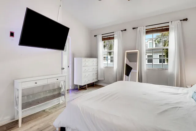 a bedroom with a bed and a flat screen tv