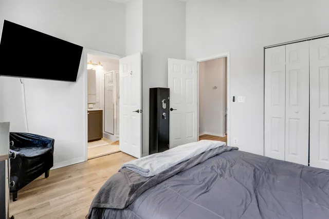 a bedroom with a bed and a flat screen tv