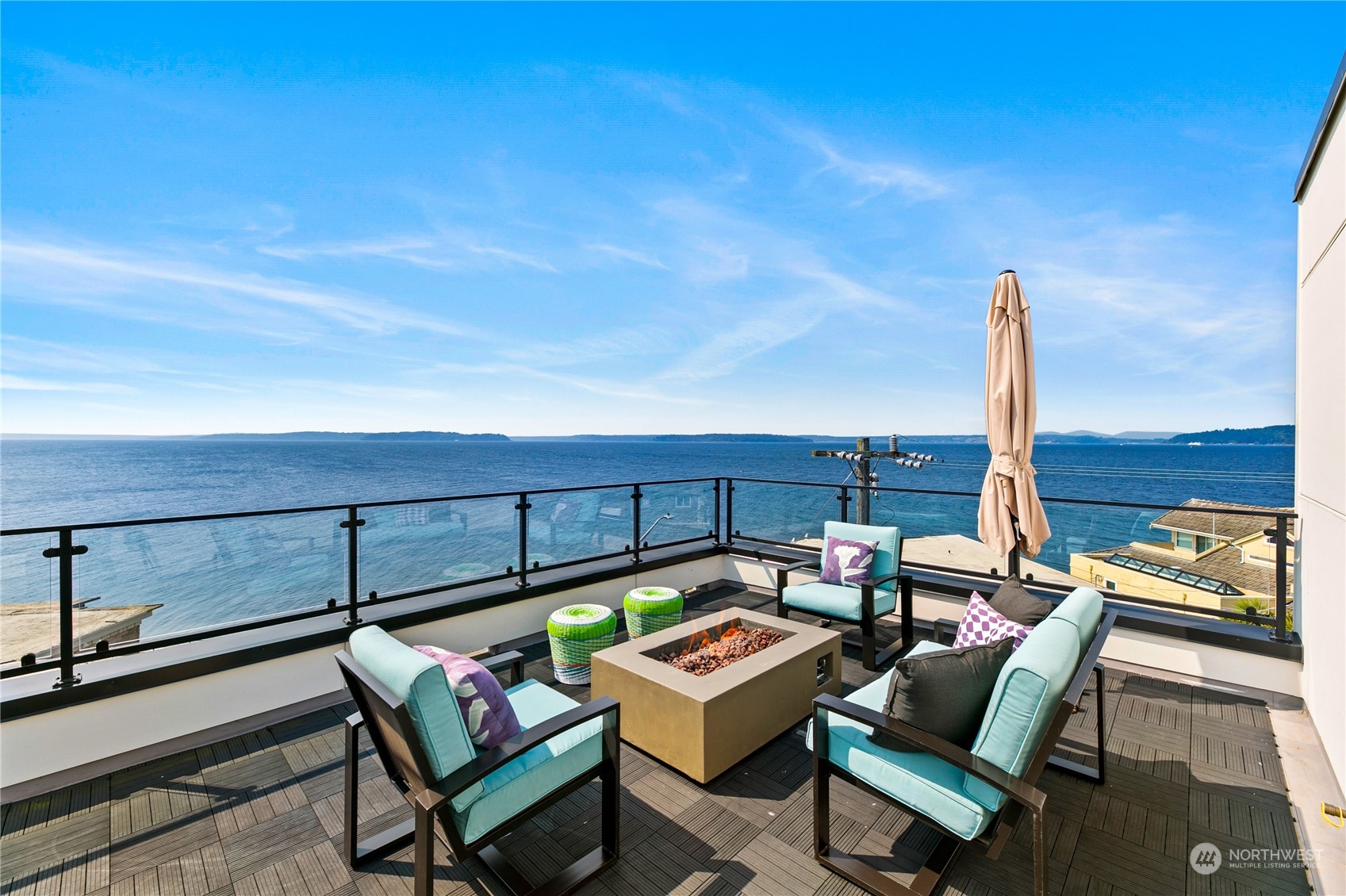a roof deck with a table and chairs