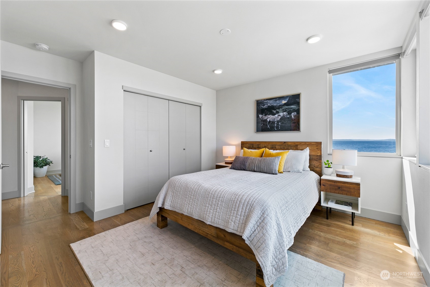 3226 Alki Avenue Southwest Seattle, WA 98116 - Photo 17 of 39 a bedroom with bed and wooden floor