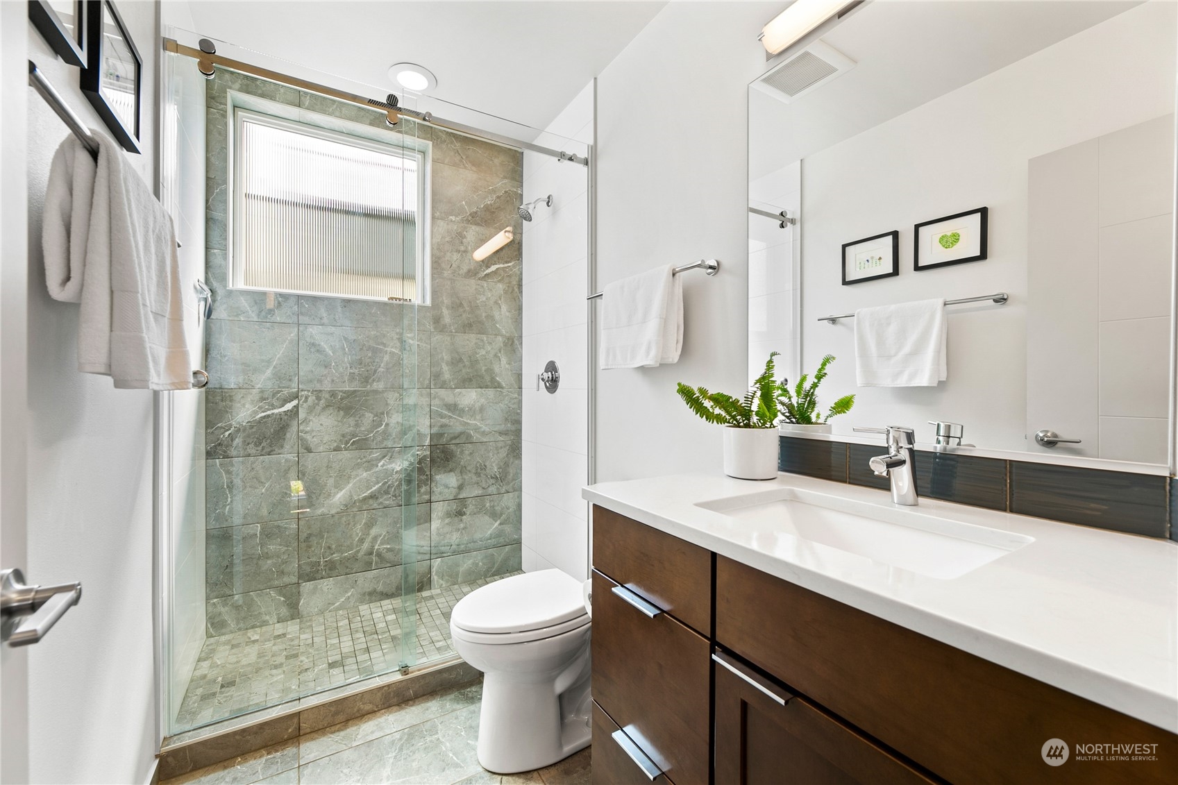 3226 Alki Avenue Southwest Seattle, WA 98116 - Photo 20 of 39 a bathroom with a granite countertop sink a toilet and shower
