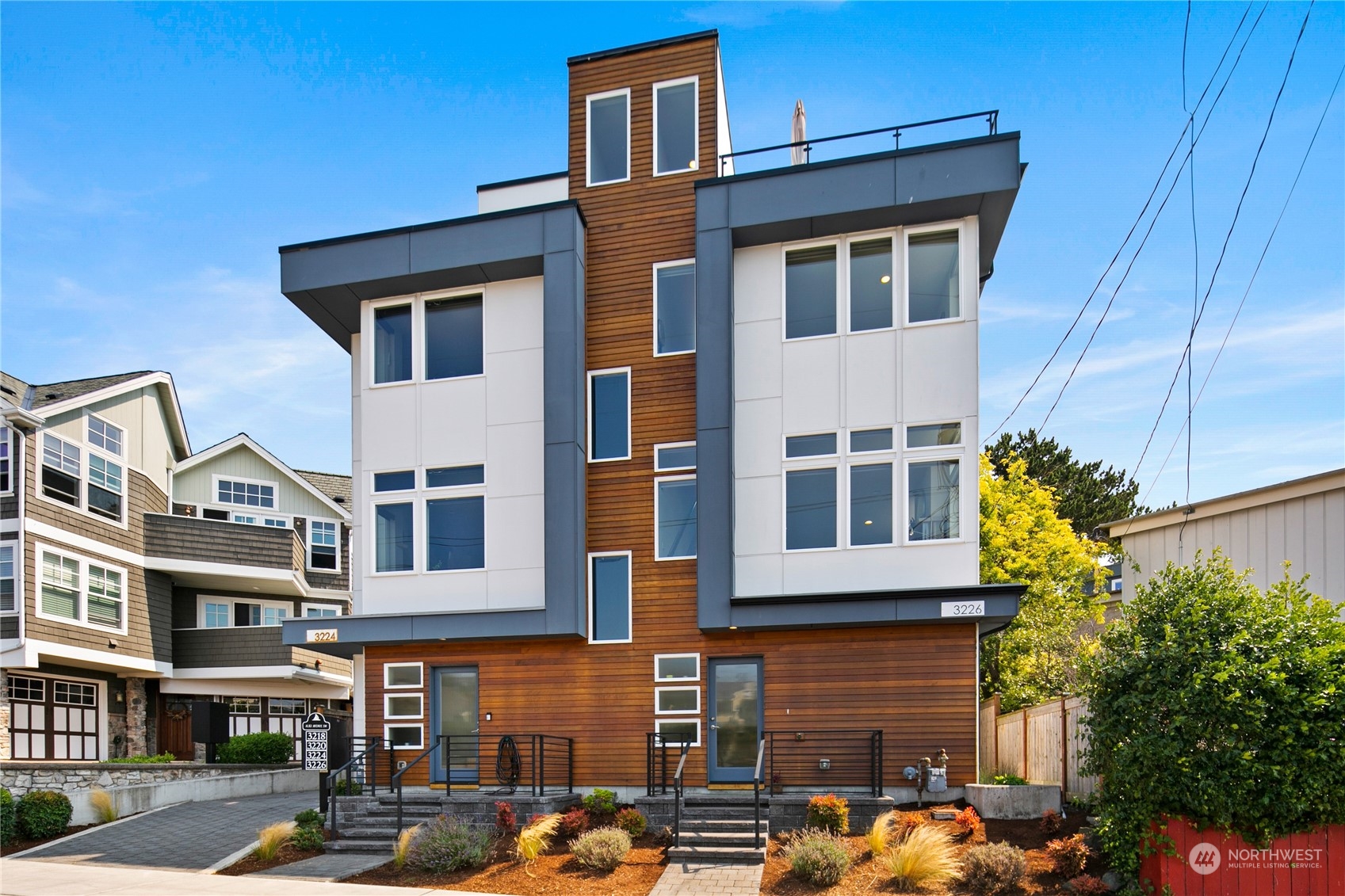 3226 Alki Avenue Southwest Seattle, WA 98116 - Photo 35 of 39 a front view of a residential apartment building with a yard