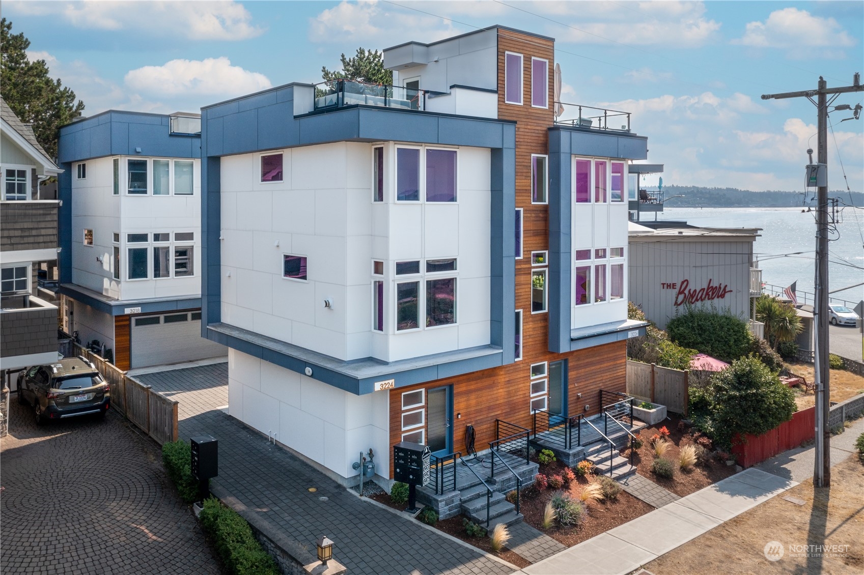 3226 Alki Avenue Southwest Seattle, WA 98116 - Photo 37 of 39 a large building with a lot of windows and potted plants