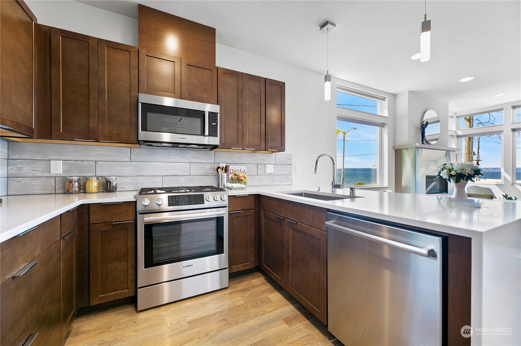 3226 Alki Avenue Southwest Seattle, WA 98116 - Photo 8 of 39 a kitchen with stainless steel appliances granite countertop a stove a sink and a microwave