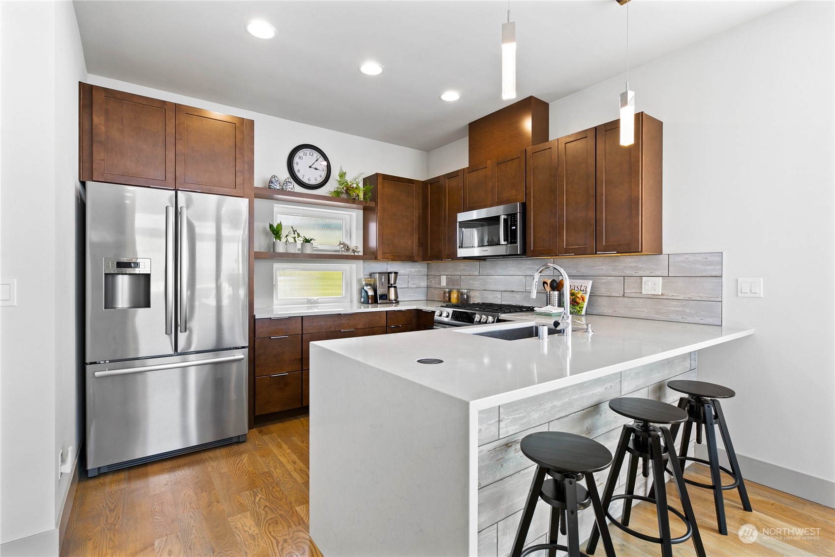 3226 Alki Avenue Southwest Seattle, WA 98116 - Photo 10 of 39 a kitchen with stainless steel appliances granite countertop a refrigerator and a sink