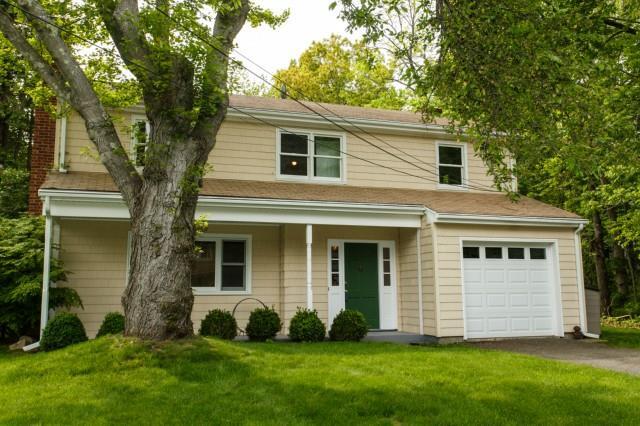 122 Lancer Road Greenwich, CT 06878 - Photo 1 of 1 a front view of a house with a garden and yard