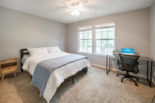 a bedroom with a bed a desk and chair