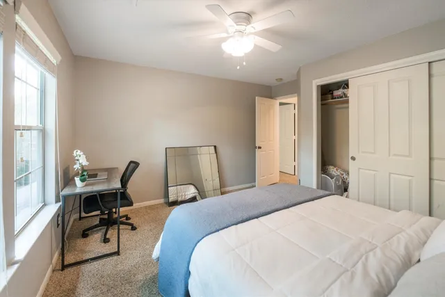 a bedroom with a bed a desk and chair