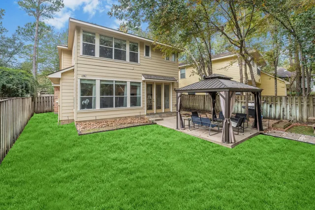a view of a house with a yard and sitting area