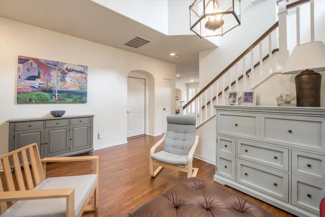 a living room with furniture and wooden floor