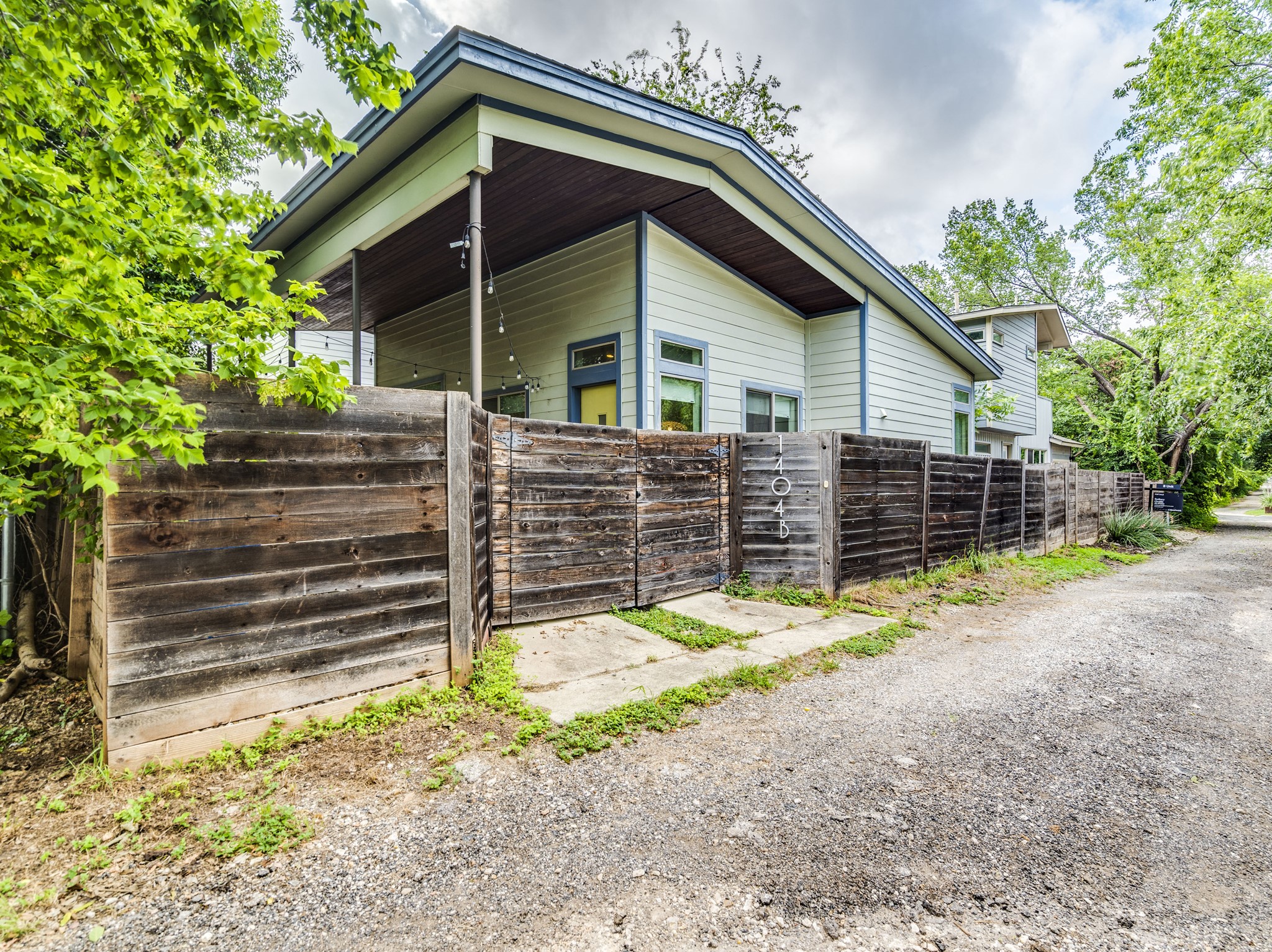 1404 Singleton Avenue, Unit B Austin, TX 78702 - Photo 20 of 21 A private wooden fence encloses the property, offering a serene outdoor retreat.