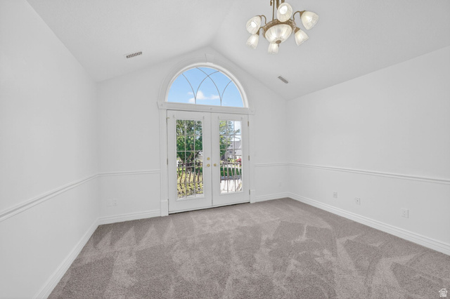 883 East 700 South Springville, UT 84663 - Photo 24 of 59 French doors with an arched transom, a vaulted ceiling, and a multi-arm chandelier