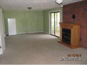 85 Todd Road Clyde, NC 28721 - Photo 4 of 11 a view of empty room with window and fireplace