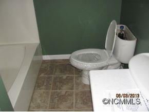 85 Todd Road Clyde, NC 28721 - Photo 6 of 11 a bathroom with a toilet and a bathtub