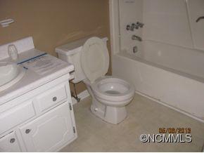 85 Todd Road Clyde, NC 28721 - Photo 7 of 11 a white toilet sitting next to a bath tub