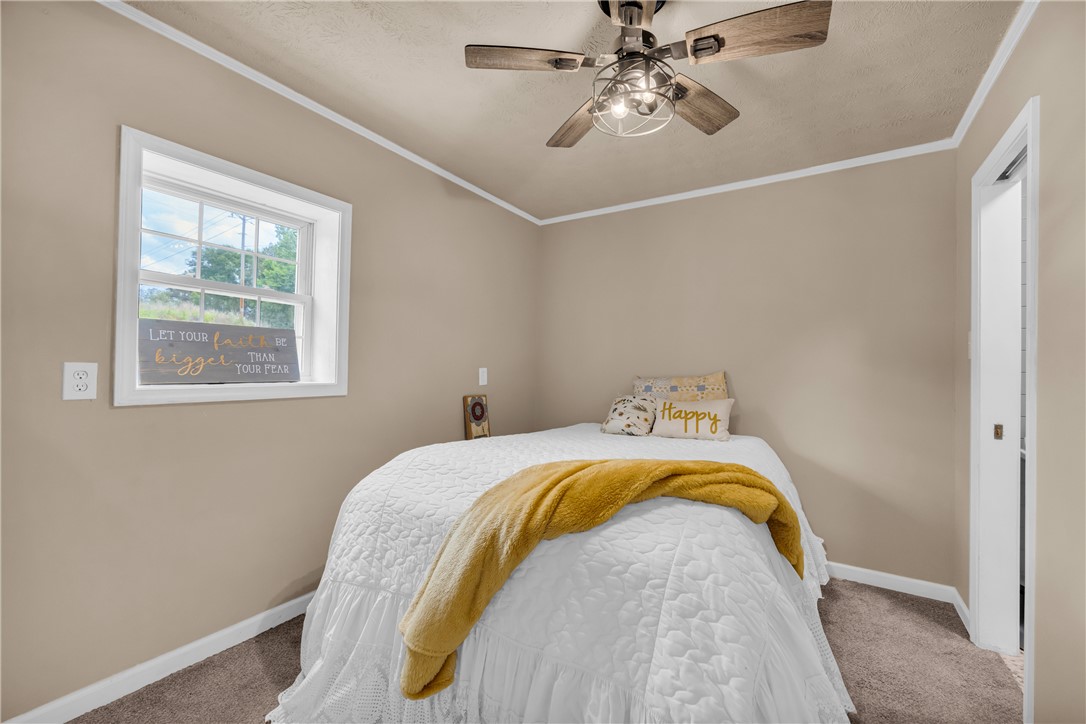 3030 Smith McGee Road Iva, SC 29655 - Photo 41 of 46 Comfortable bedroom offers a serene retreat, complete with a window and a ceiling fan.