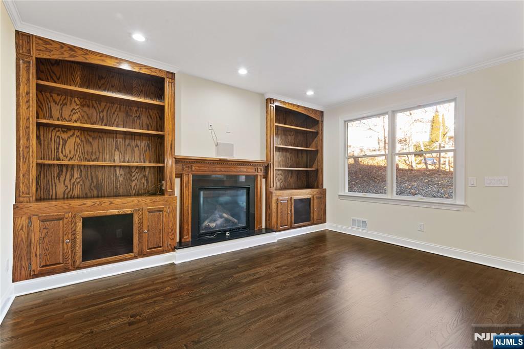 20 Grove Street Boonton, NJ 07005 - Photo 17 of 39 a view of an empty room with wooden floor fireplace and a window