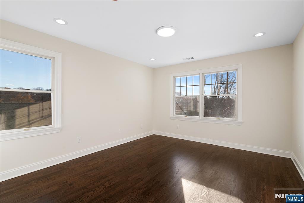 20 Grove Street Boonton, NJ 07005 - Photo 21 of 39 an empty room with wooden floor and windows