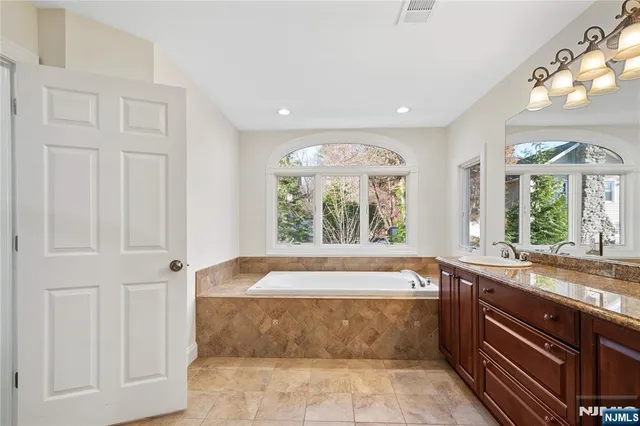 a bathroom with a bathtub and a sink