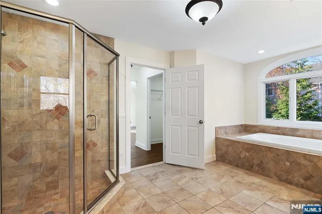 a bathroom with a tub and shower